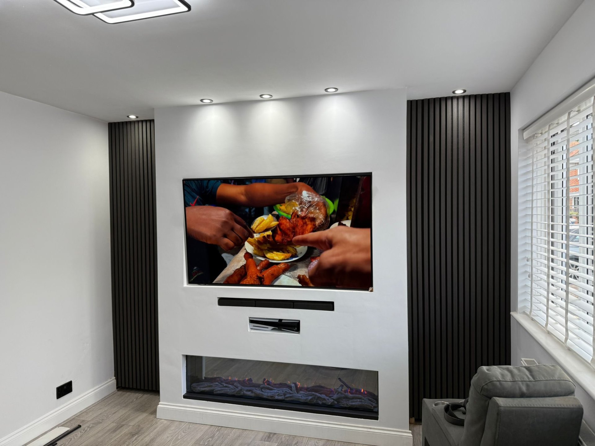 TV wall with spotlights and electric fire